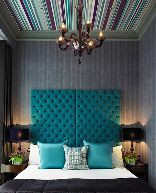  A Large Teal Headboard Is a Great Focal Point